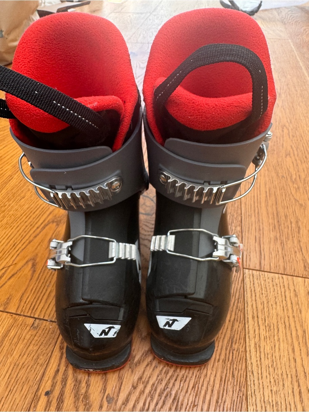 Youth Black Ski Boots with Red Liner and Secure Buckles